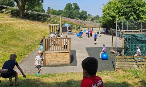 Bradwell students playing outside on various pieces of play equipment